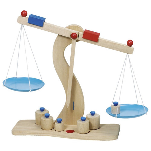 Wooden balance scale toy with colorful weights on a white background