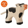 Wooden cow toy with black spots and orange nose on a white background, featuring the 'spiel gut' logo.