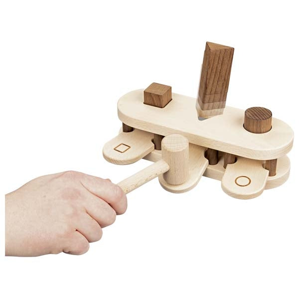 Wooden puzzle toy with a hand interacting with it on a white background
