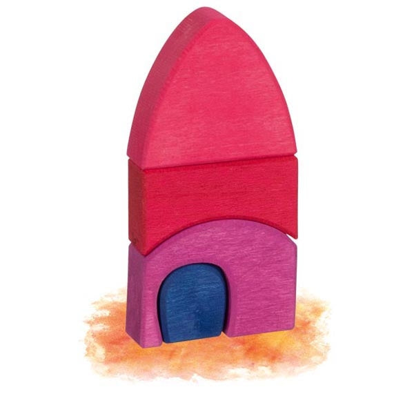 Wooden toy rocket ship with pink top and purple body on a white background