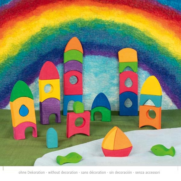 Colorful wooden toy buildings with a rainbow in the background