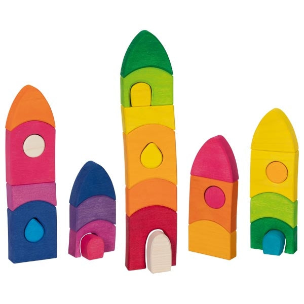 Set of colorful wooden building blocks shaped like rockets on a white background