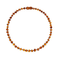 Necklace with cognac amber beads on a white background