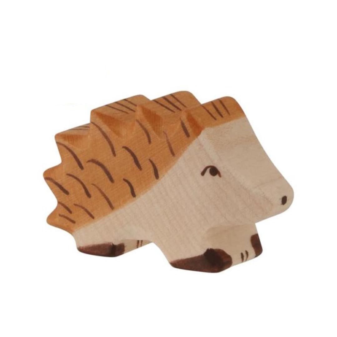 Wooden toy hedgehog on a beige background