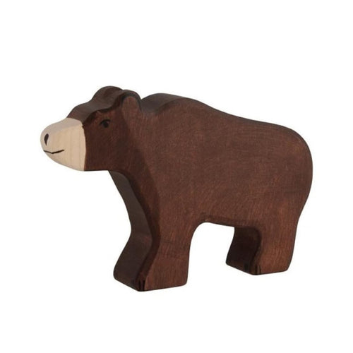 Wooden bear figure on a beige background