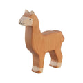 Wooden llama figure on a beige background