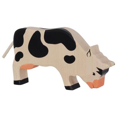 Wooden cow toy with black spots on a white background