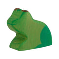 Green wooden toy frog on a white background